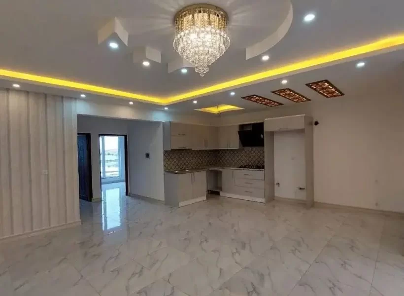 سرامیک سفید و سقف نورپردازی شده با نور زرد سالن نشیمن ویلا در شیرگاه