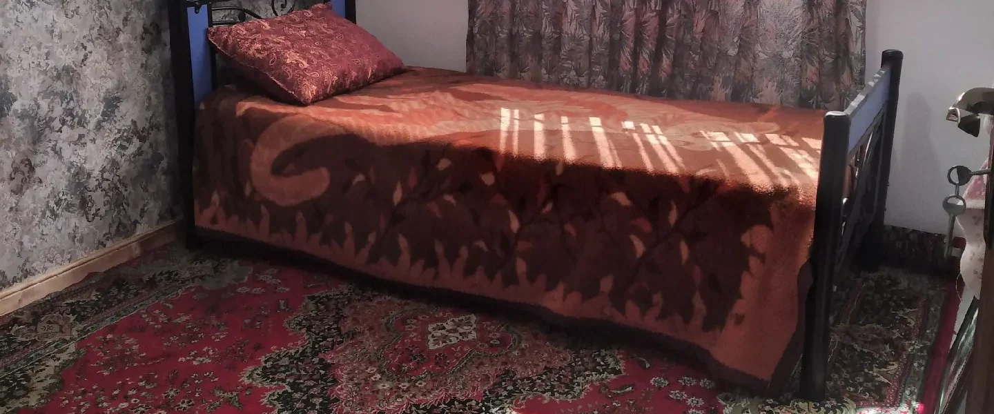 تخت خواب یک نفره در اتاق خواب فرش شده آپارتمان در بابلسر 456415